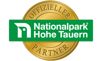 An official partner seal of the Hohe Tauern National Park. The seal is designed in gold and green.