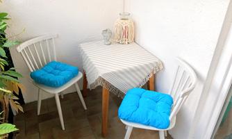 Small, sheltered seating area with a table and two chairs. Perfect for breakfast outdoors or a glass of wine in the evening.