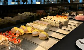 The display case of our in-house patisserie, showcasing a selection of freshly made pastries and delicate baked goods.