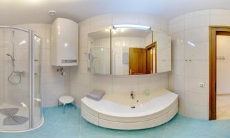 A modern bathroom with a shower, a sink, and wooden paneling. The walls are light-tiled, and the floor has a blue covering.