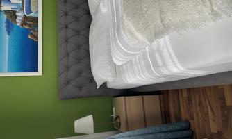 A modern bedroom with a gray bed and fresh, green walls. There is a nightstand with a lamp and curtains in blue.