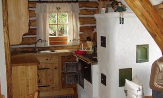A cozy kitchen in a wooden house with rustic furniture. The room has a warm atmosphere and many wooden details.