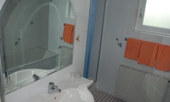 Modern, bright bathroom with shower and separate bathtub