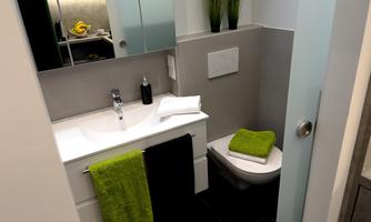 A modern bathroom with a sink and a toilet. Towels in green and black colors are ready.
