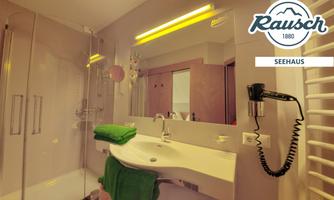 A modern bathroom with an elegant sink and a large mirror. Towels in fresh colors and a hairdryer are also available.