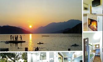 A picturesque sunset over a tranquil lake, surrounded by mountains. In the foreground, people can be seen swimming and on a pier.