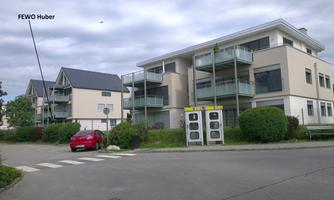 Modern residential houses in a quiet environment. A red car box is on the street.