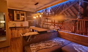 A modern living environment with rustic charm. The wooden elements and warm light create a cozy atmosphere.
