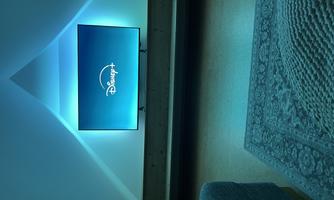A television with the Disney+ logo shines in a room. The wall has a soft, blue illumination.