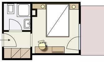 A floor plan drawing of a room with a bathroom. The bedroom contains a bed, a table, and a chair.