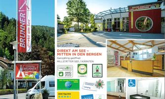 A campsite directly at Lake Millstätter, surrounded by mountains. A modern reception building and information boards display the numerous offerings.