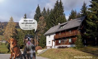 A beautiful chalet surrounded by nature, with two cheerful dogs in the foreground. The text in the speech bubble expresses happiness: "Here we are happy!"