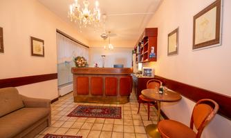 An inviting reception area with a wooden counter and a cozy seating area. Brightly lit with appealing decorations and a friendly ambiance.