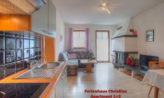 A bright and friendly apartment with a modern kitchen and a cozy seating area. The decor is stylish and invites you to relax.