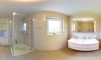 A modern bathroom with a shower and a large mirror. Bright colors and ample daylight create an inviting atmosphere.