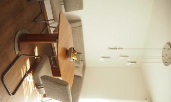 A bright dining room with an elegant wooden table and beige chairs. In the background, there is a corner with a fruit bowl as a decorative accent.