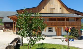 A beautiful wooden house with a green garden. The blue sky and the quiet surroundings create a pleasant atmosphere.