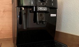 An elegant coffee machine in black stands on a wooden shelf. It features a modern design and various controls.