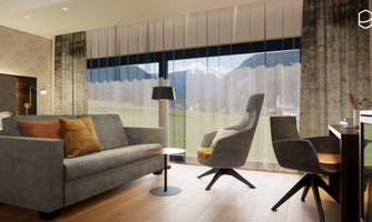 A modern living room with a gray sofa and elegant chairs. Large windows provide a view of the mountains and let in plenty of daylight.