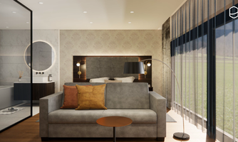A modern living room with a comfortable sofa and a small table. Large windows provide plenty of daylight and a view of the outside.