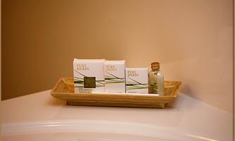A stylish tray with natural products, including soap and oil. The packaging is beautifully designed and conveys a sense of purity.