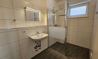 Bathroom with sink and shower.