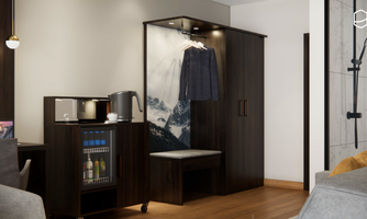 A modern hotel room with dark wood, a clothing rack, and a small bar. On the wall is a picture of snow-capped mountains.