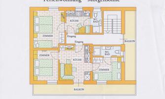 A floor plan drawing of two holiday apartments with several rooms, kitchen, and bathrooms. The apartments have balconies and are clearly structured.