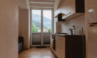 A modern kitchen with a view of the mountains. Large windows let in plenty of light.