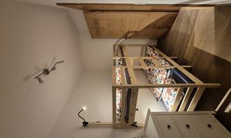 A cozy children's room with a bunk bed and colorful bedding. The room is bright and modernly furnished.