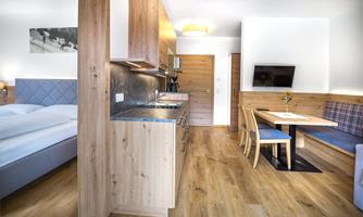 A modern living kitchen with wooden details and a cozy dining area. The bedroom is in soft colors and provides a relaxed atmosphere.