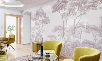 A modern living room with yellow armchairs and a glass table. The walls are decorated with a gentle tree motif.