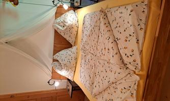 A cozy bedroom with a double bed and decorative bedding. Two nightstands with lamps complement the inviting atmosphere.