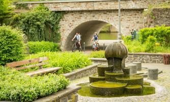 Dorfplatz mit Brunnen – der Weg zum Lahngarten