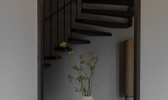 A modern staircase with an elegant staircase and soft lighting. In the foreground is a vase with flowers on a worn-out sofa.