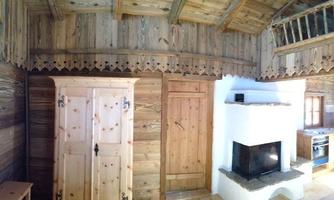 A cozy room with wooden panels and rustic furniture. A beautiful combination of modern and traditional elements.