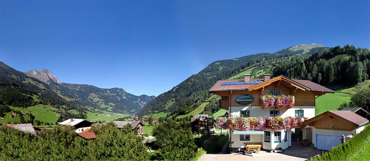 A picturesque alpine panorama with a cozy house and colorful flower boxes. The surrounding mountains and green meadows create an idyllic landscape. The holiday home features 3 new apartments and is modern and comfortably equipped. Quiet and central location in Dorfgastein in the Salzburg region. An ideal starting point for hikes and bike tours. The cable cars and the swimming pool with sauna are only 250 meters away. Very good restaurants are within walking distance. In the center of Dorfgastein, there is a public playground for children. The Alpentherme Gastein, the Felsentherme Gastein, and the Gasteiner Heilstollen can be reached in a few minutes by car. The Mitterlechner family would be very pleased to welcome you to their home!