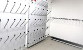 An empty room with white walls and shelves. The shelves have several permits and are ready for the storage of items.