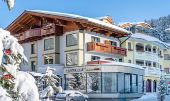A modern hotel in a snow-covered landscape. The clear blue sky creates a beautiful winter atmosphere.