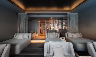 A modern relaxation room with comfortable gray loungers and elegant lighting. The cozy atmosphere invites you to relax.