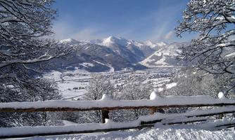 Snow-covered mountains with a clear blue sky. A peaceful winter landscape with a picturesque view.