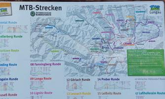 A map with various mountain bike routes in Lungau. The trails are color-coded and show the surrounding mountains.