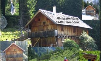 A rustic wooden cabin in the Alps, surrounded by green meadows and mountains. The Hinteralm cabin is located at an altitude of 1440 m.