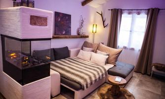 A cozy living room with a modern sofa and an elegant fireplace. Soft lighting creates a relaxed atmosphere.