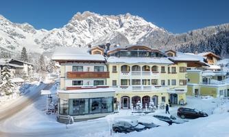 A winter hotel in the mountains, surrounded by snow-covered landscapes. The majestic mountains create an impressive backdrop.