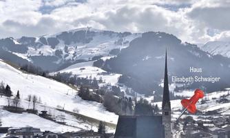 A winter landscape with snow-covered mountains and a small village in the foreground. The church has a tall tower, and a pin points to the house of Elisabeth Schwaiger.