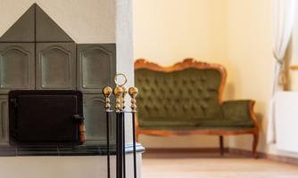 A cozy living space with a classic stove and an elegant sofa. The room is bright and inviting.