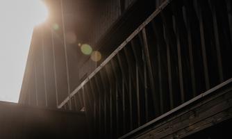 A sunbeam falls on a wooden-clad structure. The atmosphere feels warm and inviting.