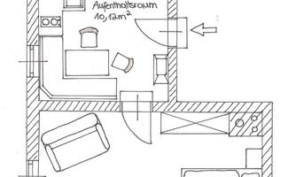 A simple floor plan drawing of an apartment. The rooms include a bedroom, a bathroom, a kitchen, and a balcony.