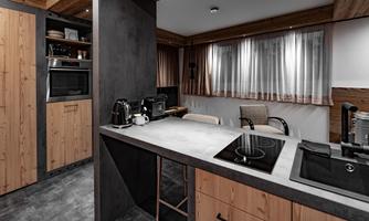 A modern kitchen with wooden shelves and a clean design. The space is bright and inviting, with appliances and seating.